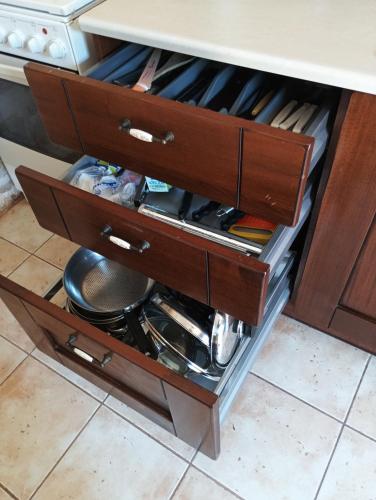 a drawer in a cabinet filled with cooking utensils at Villa Agapi 2 in Kamilari