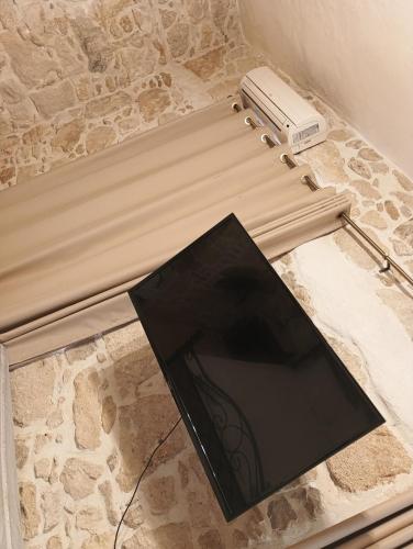 a black umbrella sitting on top of a stone counter at Villa Agapi 2 in Kamilari