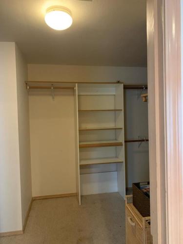 a room with a closet with shelves and a light at Cedar River Home Away From Home in Renton