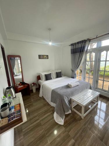a bedroom with a bed and a table in it at Mountain vibe ella in Ella