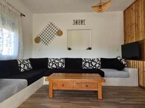 a living room with a couch and a coffee table at Casa de Mima, Casa Rural in Restinga Smir