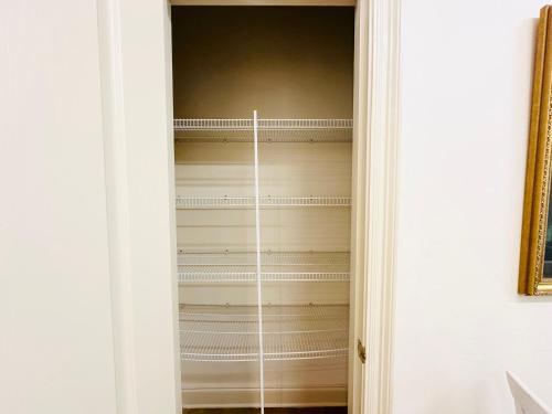 a closet with white walls and a door at Chateau 10 in Hammond