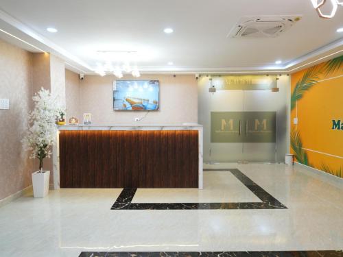 a lobby with a reception desk and a screen at Madhura Luxury Rooms in Hyderabad
