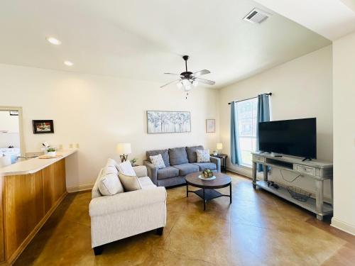 a living room with a couch and a flat screen tv at Chateau 10 in Hammond