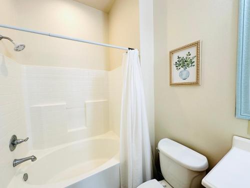 a bathroom with a white tub and a toilet at Chateau 10 in Hammond