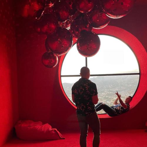 a man looking out of a round window with balloons at 2811 SECRT Sabana Hermoso Estudio in San José