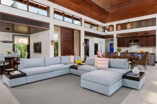 a living room with couches and a dining room at The essence of fun under a tropical sun villa in Leeward