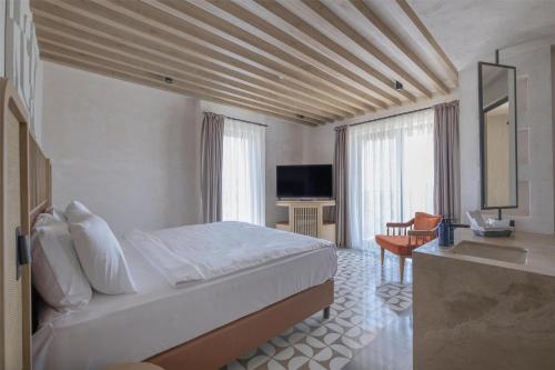 a hotel room with a bed and a television at Radisson Blu Hotel, Kas in Kas