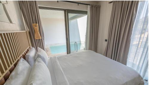 a bedroom with a bed with a large window at Radisson Blu Hotel, Kas in Kas
