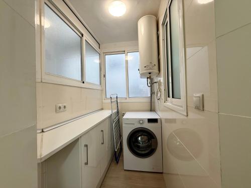 a white laundry room with a washer and dryer at 3 Double Beds - Great Area, Perfect for Families in Seville