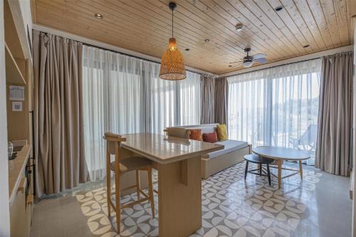 a kitchen and living room with a table and a couch at Radisson Blu Hotel, Kas in Kas