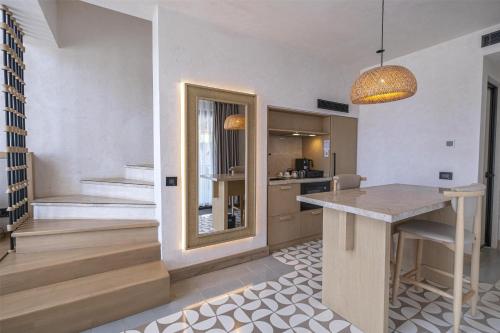 a kitchen with a counter and a table in a room at Radisson Blu Hotel, Kas in Kas