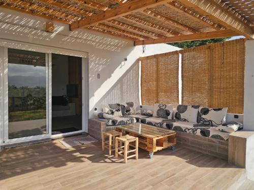 a patio with a couch and a coffee table at Casa de Mima, Casa Rural in Restinga Smir