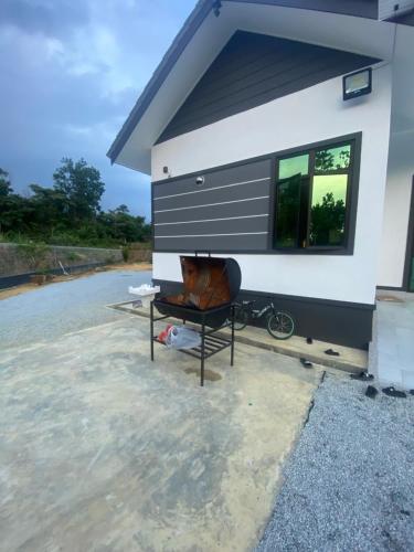 a tiny house sitting on top of a lot at Permai Homestay in Kampong Burok