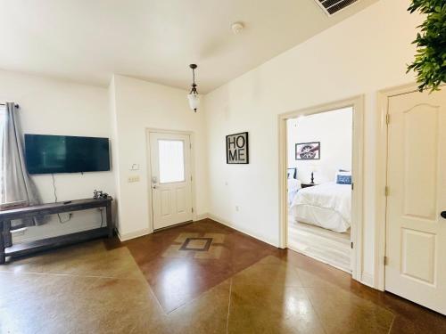 a white room with a bed and a television at Chateau 6 in Hammond