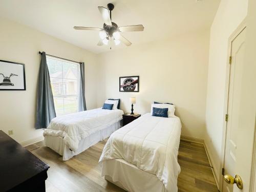 a bedroom with two beds and a ceiling fan at Chateau 6 in Hammond
