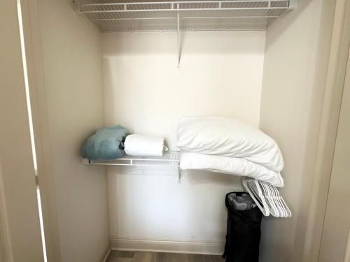 a walk in closet with two beds and towels at Chateau 6 in Hammond