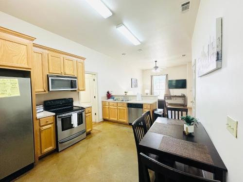 a kitchen with wooden cabinets and a table with a dining room at Chateau 6 in Hammond