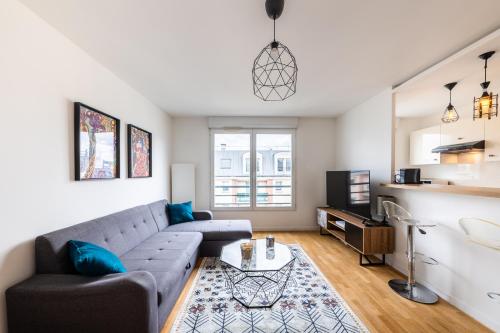 a living room with a couch and a table at Chic&Cosy 1-Bedroom Apart,2 min Metro,10 min Paris in Villejuif