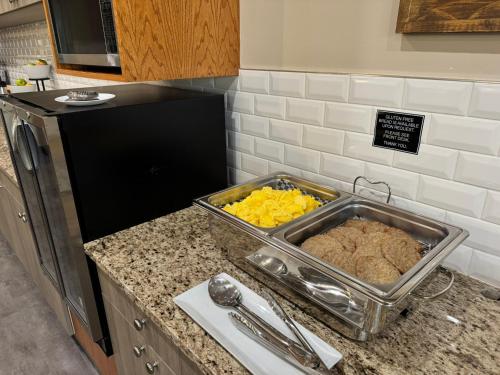 a kitchen counter with a tray of food on it at Western Budget Motel Leduc #3 in Leduc
