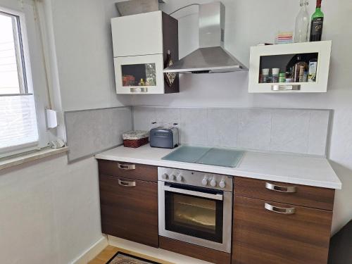 a kitchen with a sink and a stove top oven at Ferienwohnung Würzberg - Odenwald in Michelstadt
