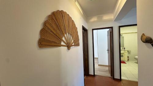 a fan is hanging on a wall in a bathroom at Casa da Mãe in A dos Cunhados