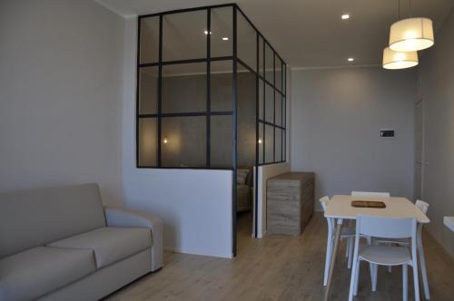 a living room with a couch and a table at Anaka sweet home in Agrigento
