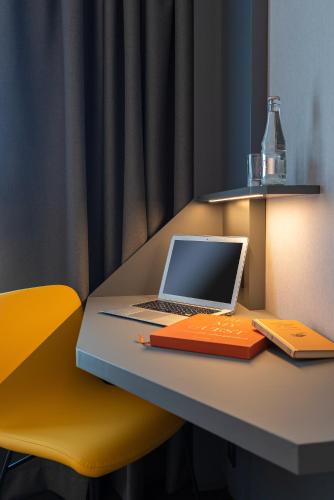 a laptop computer sitting on top of a desk at Mercure Montpellier Centre Antigone in Montpellier