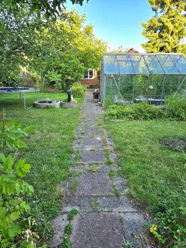 a garden with a stone path in the grass at Irenes Anneks in Nyborg