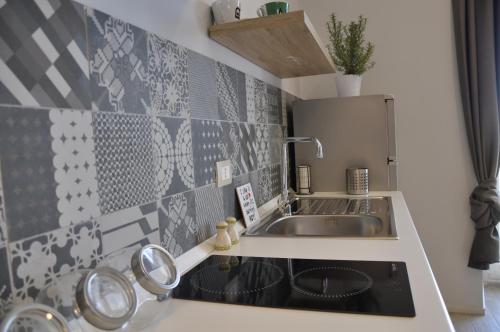 a small kitchen with a sink and a stove at Anaka sweet home in Agrigento