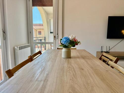 a vase of flowers sitting on a wooden table at Torrenieri House in Torrenieri