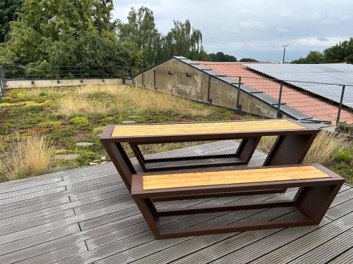 a wooden bench sitting on top of a wooden deck at Ferienwohnung Zweinig05 in Zweinig