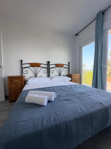 a bedroom with a large bed with two towels on it at Apartamento VistaSol in Rincón de la Victoria