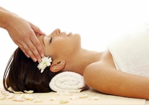 a woman laying on the floor getting a massage at SBV Luxury Ocean Hotel Suites in Miami Beach