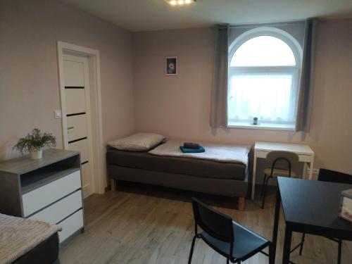 a small room with a bed and a window at Motel Vega in Sezimovo Ústí