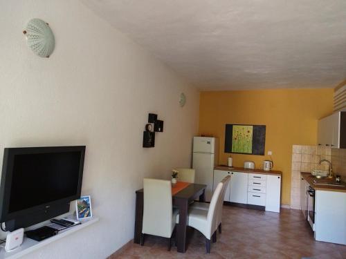a living room with a table and a kitchen at Apartments Pasha in Blagaj