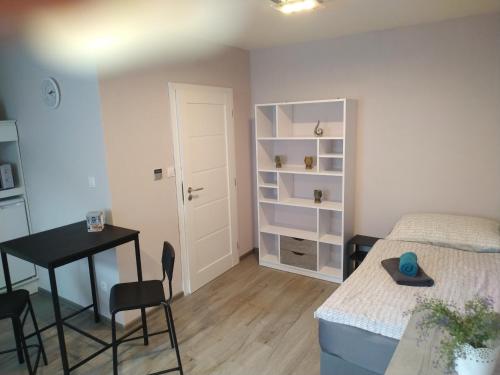 a bedroom with a bed and a desk and a table at Motel Vega in Sezimovo Ústí