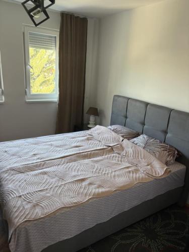 a large bed in a bedroom with a window at Micho Apartment in Ohrid