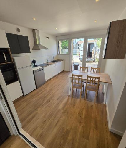 a kitchen and dining room with a table and chairs at Gites des ammonites 2 in Montalieu-Vercieu