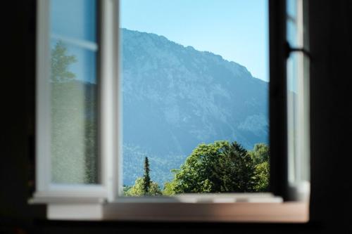 a window with a view of a mountain at The Townhouse Ruhpolding - Individual Design & Casual Concept in Ruhpolding