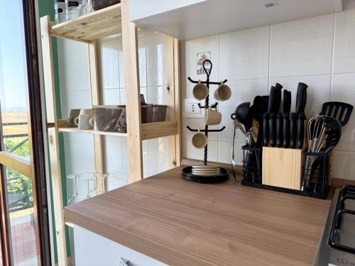 a kitchen with a wooden counter top with utensils at Torrenieri House in Torrenieri