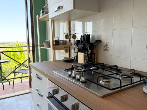 a stove top in a kitchen with a balcony at Torrenieri House in Torrenieri