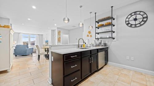 a kitchen with a sink and a clock on the wall at Spacious 2 bd-2 ba in the Heart of Asbury Ave in Ocean City