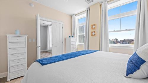 a bedroom with a large bed and a window at Spacious 2 bd-2 ba in the Heart of Asbury Ave in Ocean City