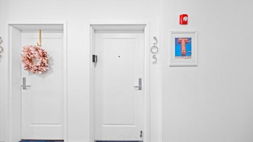 two white doors with a wreath on them at Spacious 2 bd-2 ba in the Heart of Asbury Ave in Ocean City
