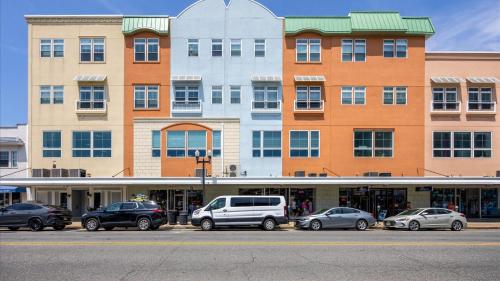 a large building with cars parked in front of it at Spacious 2 bd-2 ba in the Heart of Asbury Ave in Ocean City