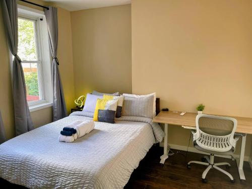 a small bedroom with a bed and a desk at Cozy 2BR Brick Haven! Near light rail! 35m to NYC in Jersey City