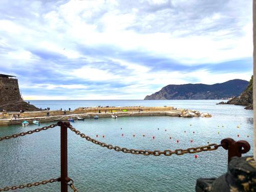a view of a body of water with a pier at The Sea Terrace Vernazza in Vernazza