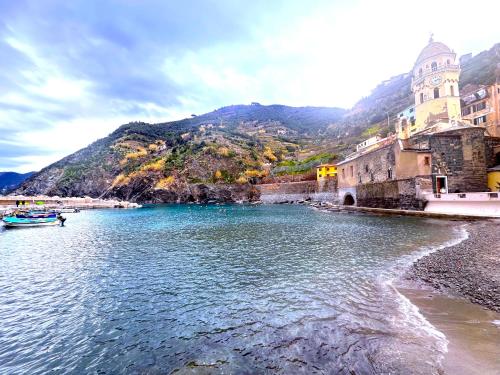 a body of water with a mountain in the background at The Sea Terrace Vernazza in Vernazza