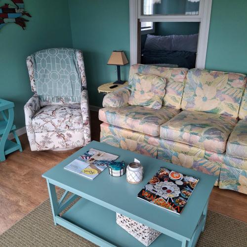 a living room with a couch and a coffee table at Little Oyster Oasis in White Stone